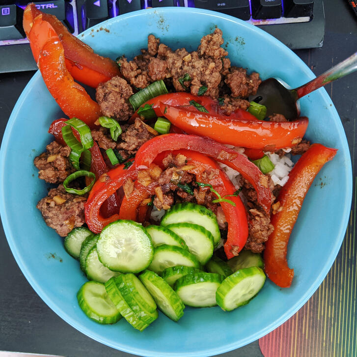 beef Teriyaki over rice with vinegar cucumber and fried red pepper